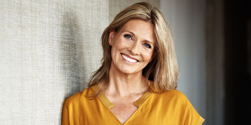 Blonde, middle-aged woman with beautiful smile.